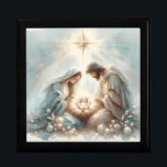 Radiant Holy Family Nativity Scene Gift Box<br><div class="desc">This serene Holy Family nativity design centers on a radiant newborn beneath a brilliant guiding star, surrounded by gentle celestial glow and soft watercolor light that evokes reverence and peaceful Christmas wonder. Mary and Joseph lean close in quiet devotion, their flowing robes painted in calming pastel blues and warm neutrals...</div>