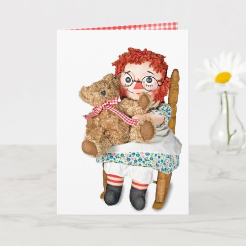 Rag doll and teddy bear in chair card