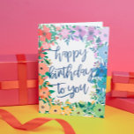 Rainbow Flowers Brush Script Happy Birthday Card<br><div class="desc">Rainbow colored happy birthday card with a frame of flowers in red,  orange,  yellow,  green,  blue,  and purple with happy birthday to you written in a charming blue brush script.</div>