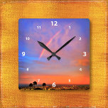 Rainbow orange blue sunset sky landscape photo square wall clock<br><div class="desc">Appreciate the beauty of nature whenever you check the time on this photography wall clock of a rainbow nestled in a blue, pink, and orange softly lit sunset. Your choice of a round or square clock face. Makes a great housewarming gift! You can easily personalize this wall clock plus I...</div>