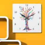Rainbow Tree Square Wall Clock<br><div class="desc">This whimsical clock is decorated with a print of a Tree Of Life design in rainbow colors. The tree was originally made in mosaic using tiny fragments of brightly colored glass. Because we create our own artwork you won't find this exact image from other designers. Original Mosaic © Michele Davies....</div>