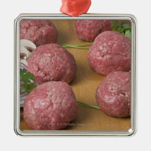 Raw meatballs on a cutting board metal ornament