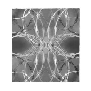 Razor wire against dark clouds notepad