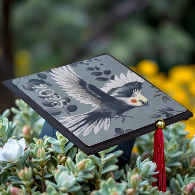 Realistic Cockatiel Bird in Flight Elegant Gray Graduation Cap Topper (Graduation cap topper decoration with a gray cockatiel in flight among soft eucalyptus leaves.)