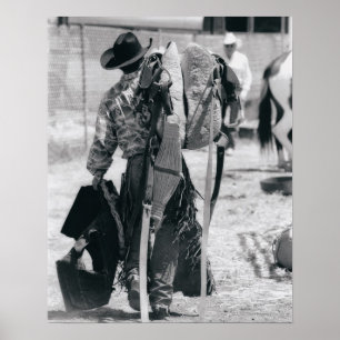 Rear view of cowboy hauling gear poster