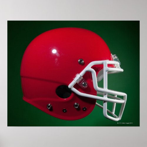 Red American football helmet on green background Poster