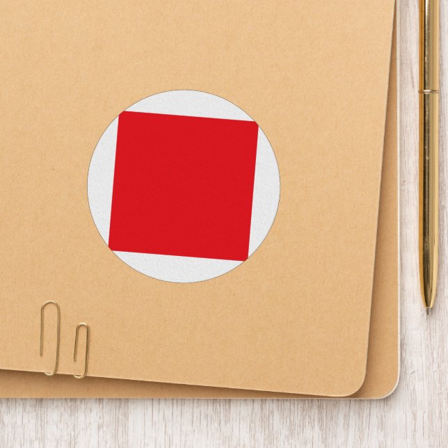 Red and orange crayons lying side by side on a whi patch (On Folder)