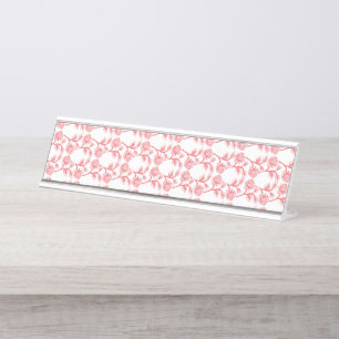 Red and pink wrapping paper featuring a repeating desk name plate