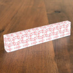 Red and pink wrapping paper featuring a repeating desk name plate