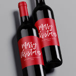 Red and White Brush Script Merry Christmas Wine Label<br><div class="desc">Festive holiday wine labels featuring "Merry Christmas" displayed in white brush script lettering with a red background. Personalize the Merry Christmas wine labels with your family name and the year displayed in white lettering.</div>