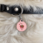 Red And White Candy Cane With A Bow And Holly Pet ID Tag<br><div class="desc">Destei's original illustration of a red and white striped Christmas candy cane treat decorated with a red bow and a Christmas holly / Common holly plant. The background color is pink. On the other side there are two personalizable text areas.</div>