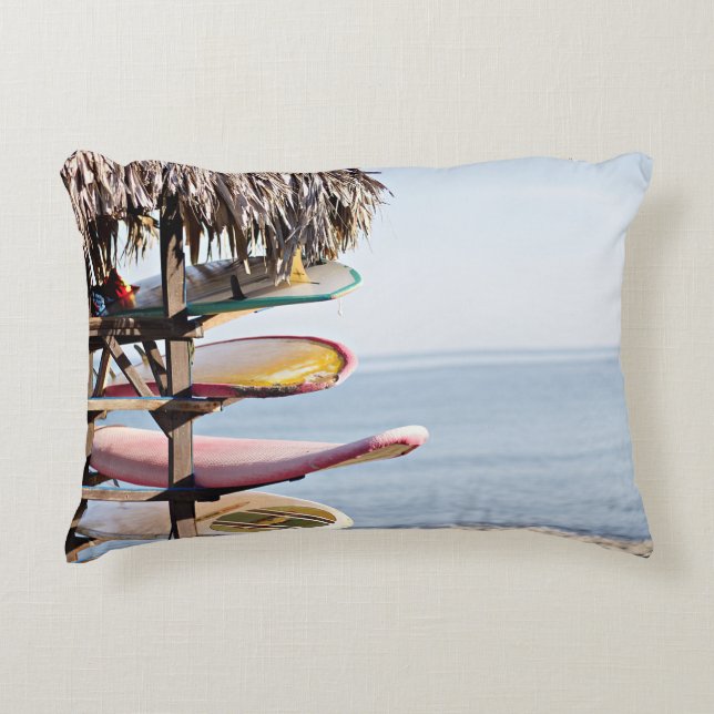 Red and white surfboard in brown wooden rack accent pillow (Front)