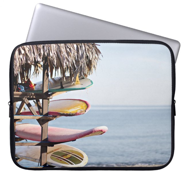 Red and white surfboard in brown wooden rack laptop sleeve (Front)