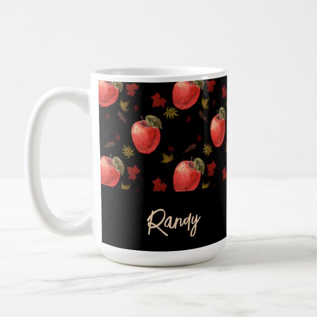 Red apples and leaves on black coffee mug (Left)