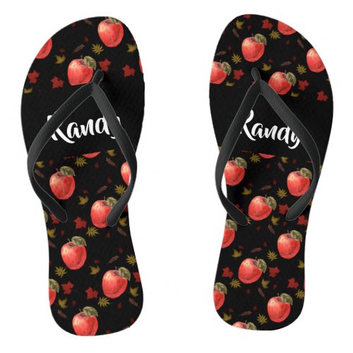 Red apples and leaves on black flip flops