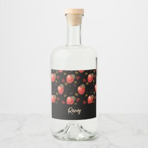 Red apples and leaves on black liquor bottle label