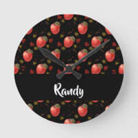 Red apples and leaves on black round clock