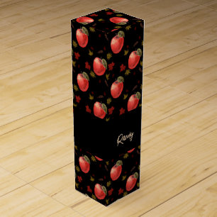 Red apples and leaves on black wine box
