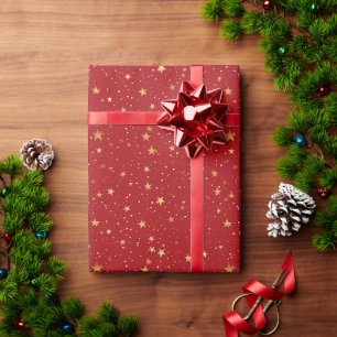Red Background With Gold Stars And Snowflakes Wrapping Paper