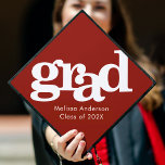 Red bold simple modern graphic typography name graduation cap topper<br><div class="desc">Your favorite grad will stand out and make a statement when they wear this graduation cap topper! Let them celebrate their milestone with this stunning, simple, modern, custom graduation keepsake. Bold, graphic, white typography overlays a brick red background. Personalize with your grad’s name and class year. Matching announcements, address labels,...</div>