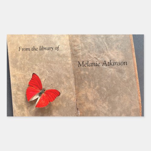 Red butterfly on vintage book pages rectangular sticker