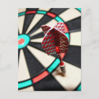 Red checkered dart on dartboard postcard