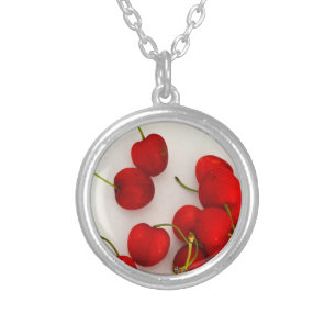 Red Cherries in Natural Light Lay on White Silver Plated Necklace