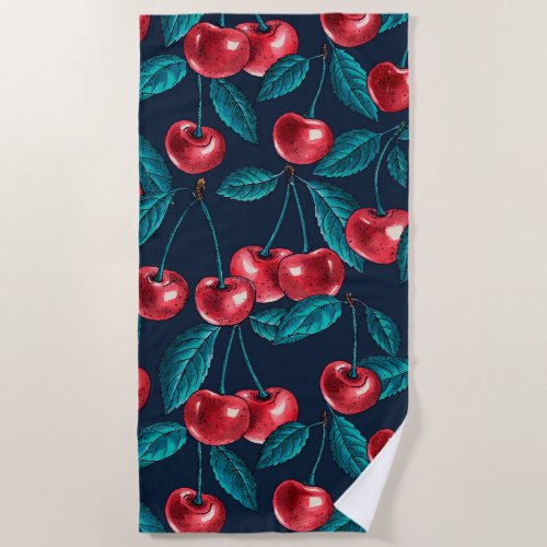 Red cherries on dark blue beach towel