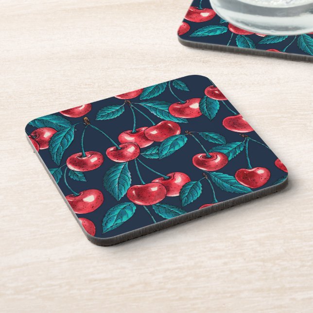 Red cherries on dark blue beverage coaster (Left Side)