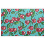 Red cherries on turquoise fabric