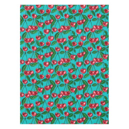 Red cherries on turquoise tablecloth