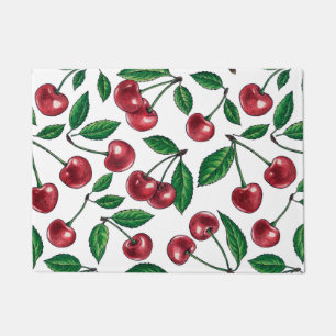 Red cherries on white doormat