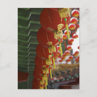 Red Chinese lanterns hanging from temple Postcard