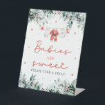 Red Christmas Santa Babies Are Sweet Take a Treat Pedestal Sign<br><div class="desc">The Red Santa Gender Neutral Santa Baby Clothes Christmas Babies Are Sweet Sign brings an adorable, festive touch to your holiday baby shower! Featuring a vibrant red design with snowflakes, seasonal eucalyptus greenery, and charming Santa-inspired baby clothes, this sign is perfect for decorating your dessert or sweets table. It warmly...</div>