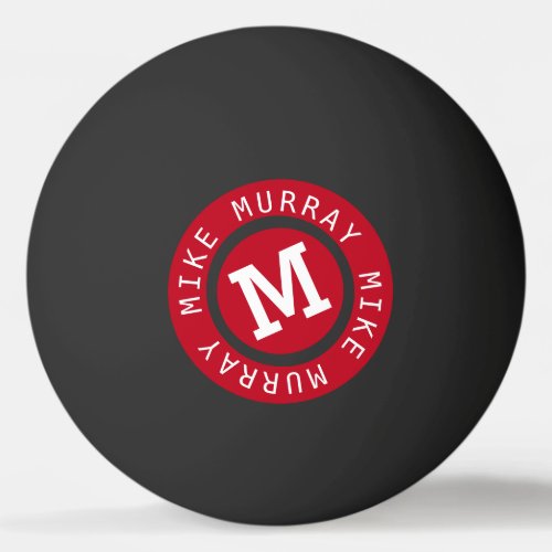 red circle monogram on black ping pong ball