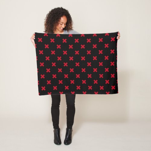 Red cross stitches on black fleece blanket