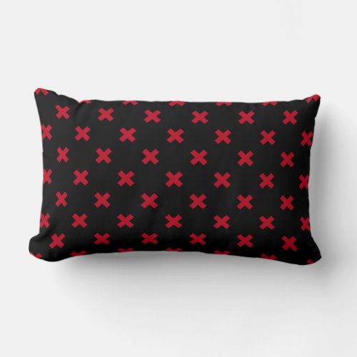 Red cross stitches on black lumbar pillow