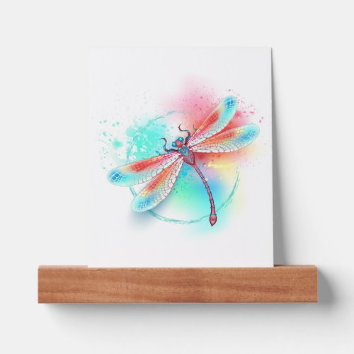 Red dragonfly on watercolor background picture ledge