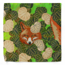 RED FOX AMONG THE GREEN LEAVES AND FOLIAGE