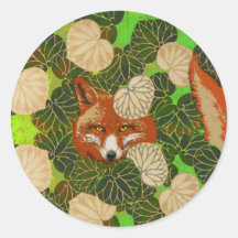 RED FOX AMONG THE GREEN LEAVES AND FOLIAGE