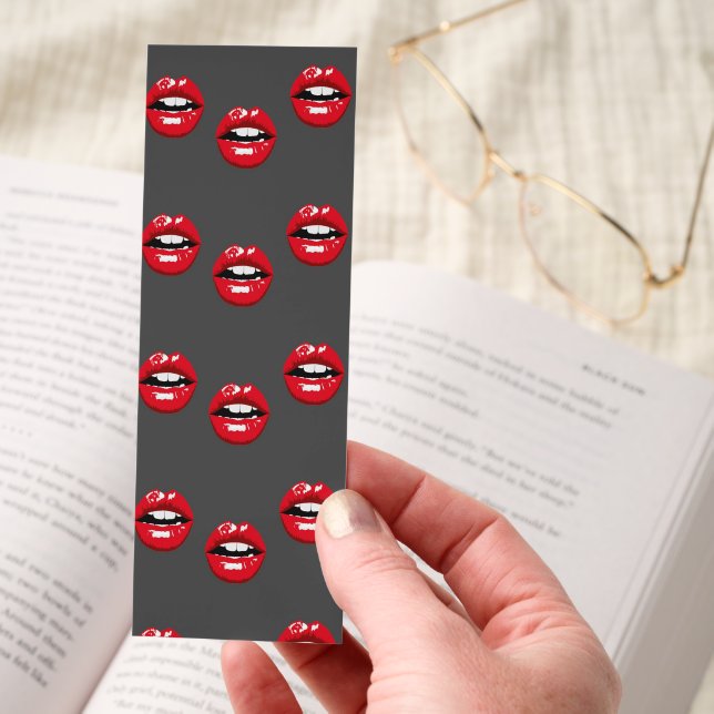 Red glossy lips on gray bookmarks (Hand)