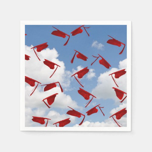 Red graduation caps in sky napkins