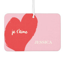 Red heart with je t’aime-text on pink background