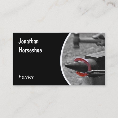 Red horseshoe hammered on an anvil business card
