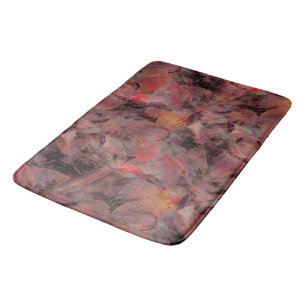 Red-hued patches on grainy black gray background t bath mat