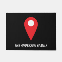 Red location icon on black mat with name