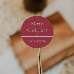Red | Modern Bow Simple Minimal Christmas Classic Round Sticker<br><div class="desc">Finish your holiday mailings and gifts with these sweet and simple Christmas stickers,  customizable with your preferred holiday greeting and family signature (shown with "Merry Christmas") on a red background. A petite bow running through the center completes this elegant minimalist holiday design.</div>