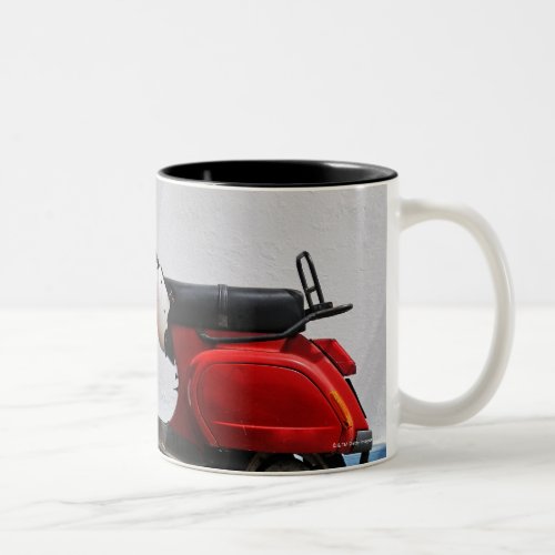 Red motor scooter by wall Stromboli Island Two_Tone Coffee Mug