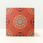 Red Orange Gray Ethnic Bohemian Folk Art Pattern Ceramic Tile<br><div class="desc">The central motif of this ceramic tile is a star-like pattern, formed by the intersection of various shapes. This centerpiece is surrounded by angular patterns that radiate outward, creating a dynamic appearance that seems to evoke a sense of movement and energy. The color palette is a striking combination of burnt...</div>