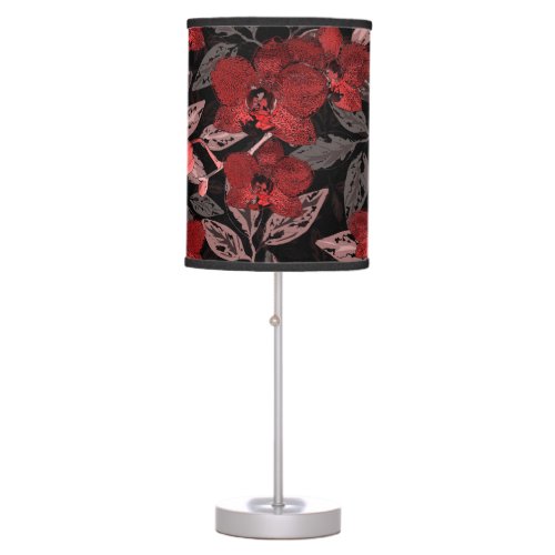 Red orchids on black table lamp